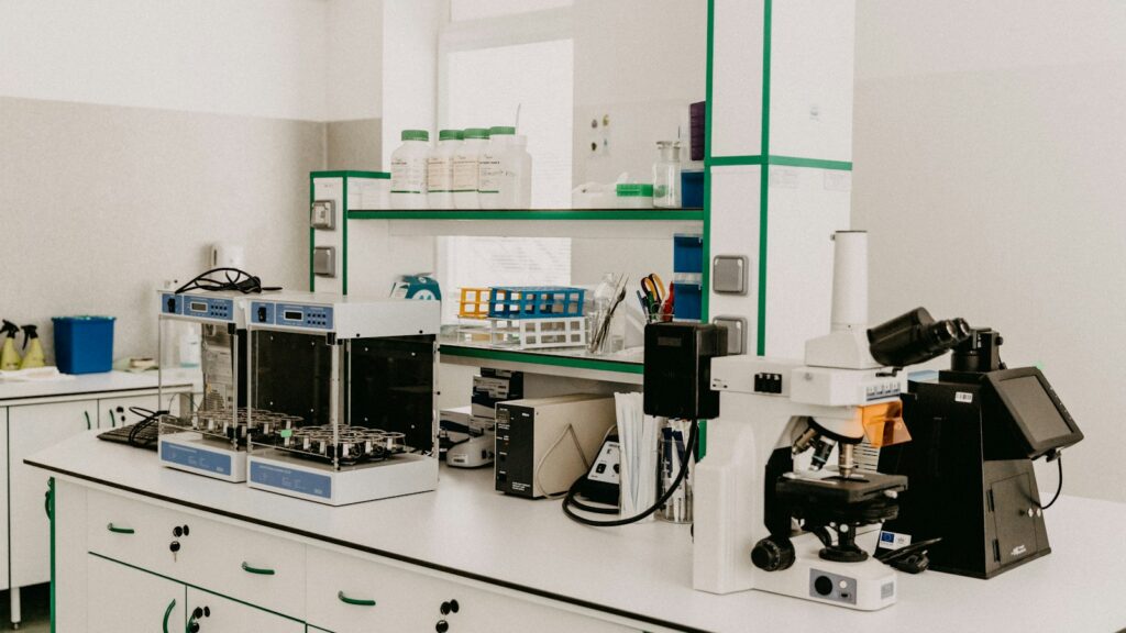 Laboratory workbench with a microscope and analytical equipment in a bright room