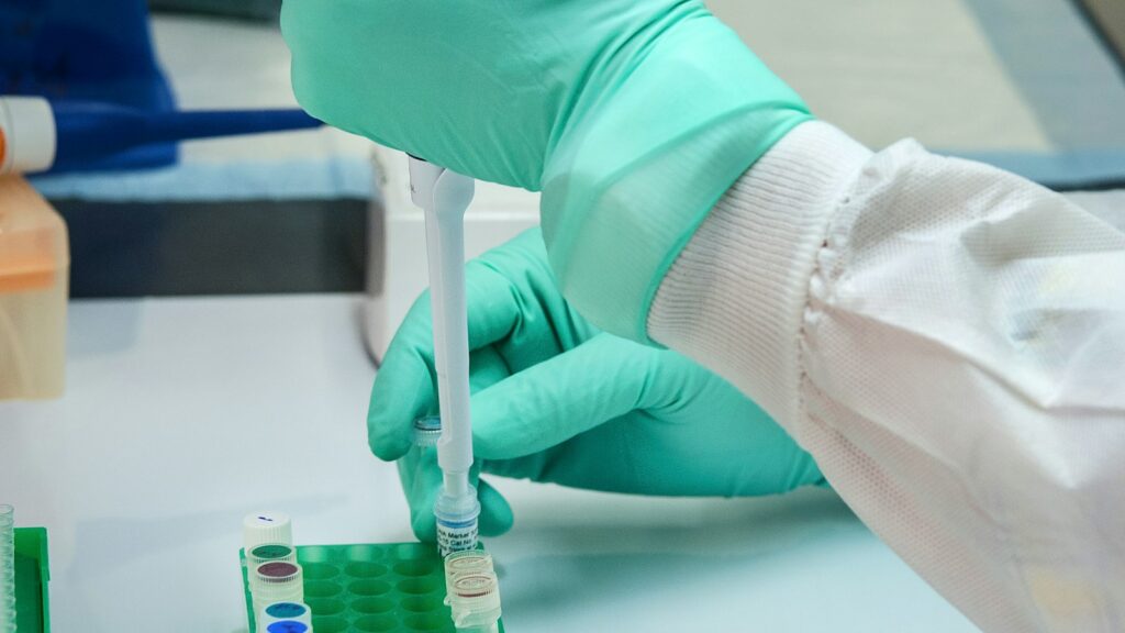 How Research Peptides Are Made: Solid-Phase Peptide Synthesis Explained 1 Gloved hand using a pipette to fill a small vial in a laboratory