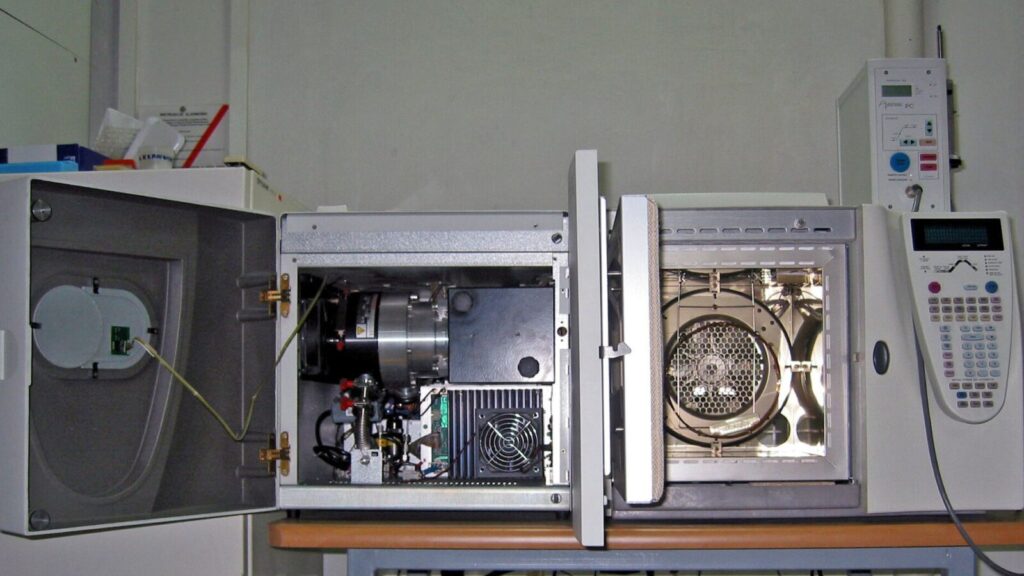 Gas chromatograph–mass spectrometer with its door open in a laboratory