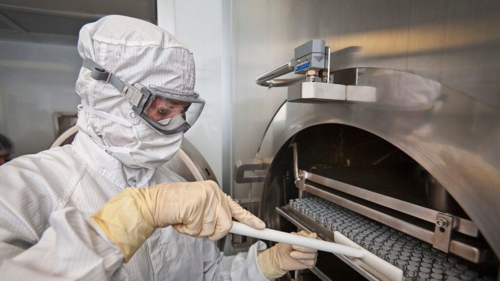 Rows of glass vials being loaded into a lyophilizer for freeze-drying
