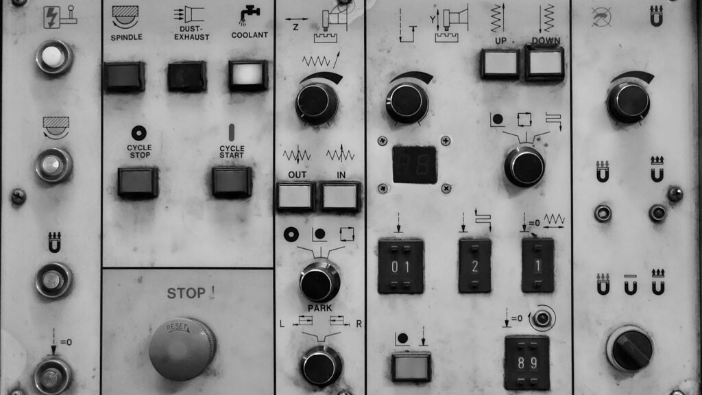 NF-κB Explained: The Switch Behind Inflammation Research 1 Close-up of an industrial electrical control panel with rows of buttons, switches and dials