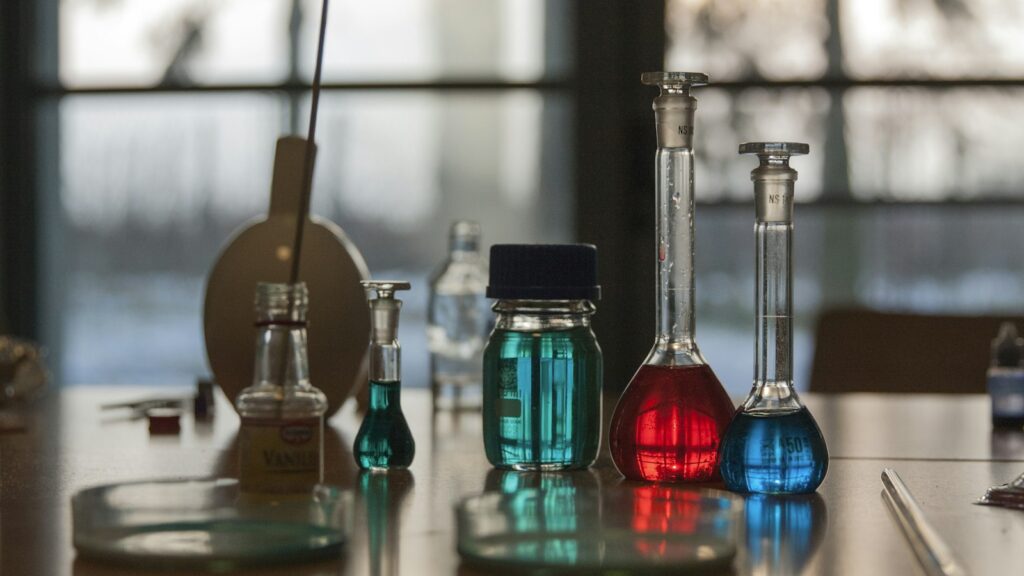 Laboratory flasks filled with liquid on a bench