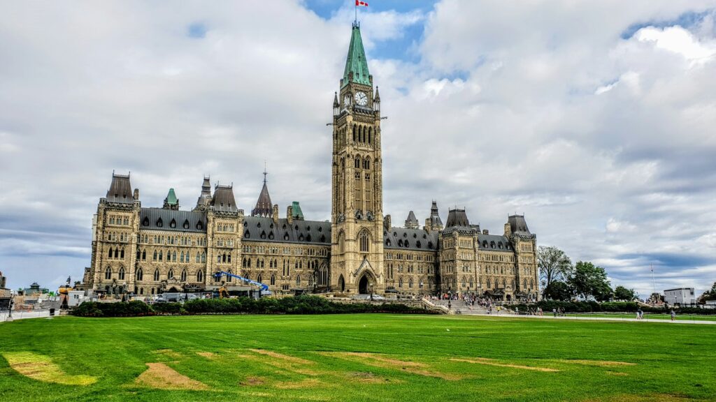Centre Block and the Peace Tower on Parliament Hill in Ottawa under a cloudy sky