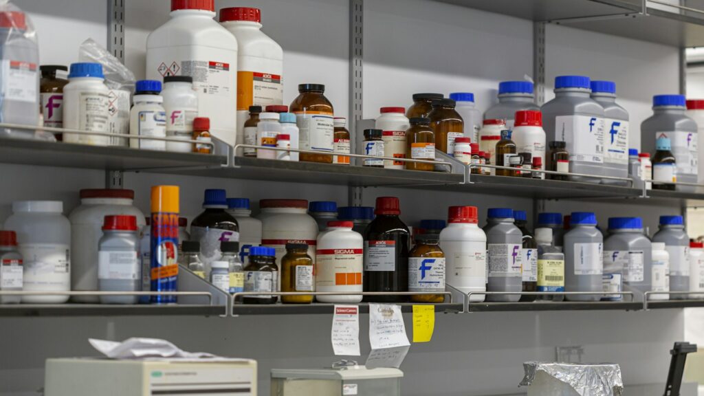 Laboratory shelves filled with bottles of chemicals